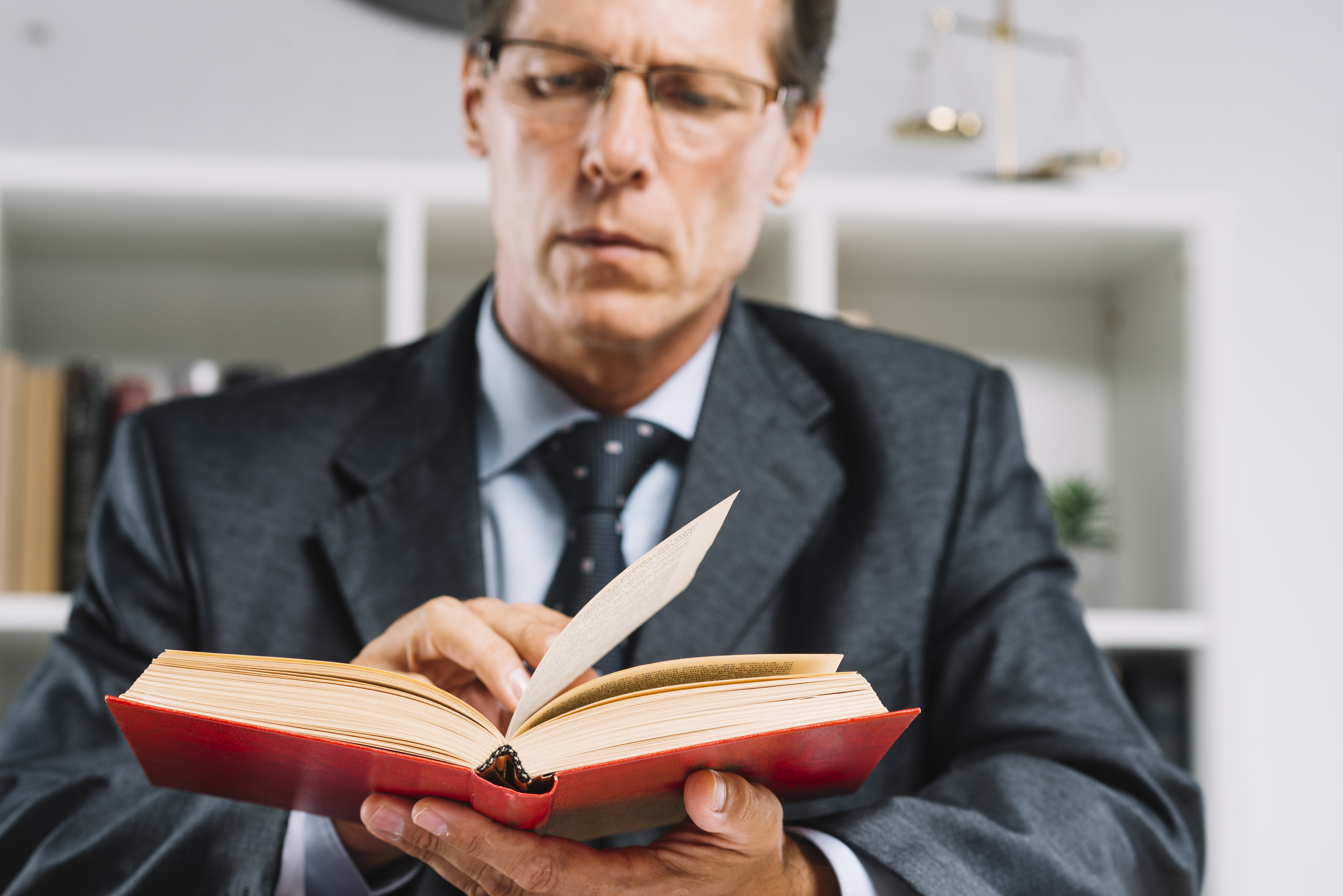 mature-male-judge-reading-book-courtroom
